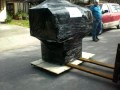 Rigger Unloading Mikini Mill from Truck to Garage