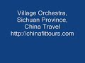 passing through what clearly was a very small village, this one near leshan, some 80 miles south of chengdu in sichuan province, western china, one gets a surprise passing by a house where a village orchestra practices. the atmosphere is relaxed but the players are very much focused on the piece played. they may be amateur musicians although it is evident they perform on many an occasion on stage. the traditional chinese musical instruments give the sound its unique tone, and with the voices permeate the otherwise quiet and unassuming village surroundings with touch of grandeur.