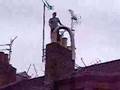 Man Trying To Fit Chimney Flue Liner Into Glasgow Tenement