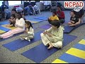 Photo of children with disabilities in a yoga class performing chanting/ music therapy.