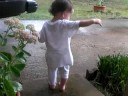 Tessa playing in the flower bed after a rain