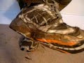 Wet and muddy Asics trainers on the carpet
