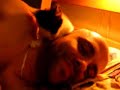 Scampi, our cute kitten, nursing on Aidon's earlobe. Look at the paws!