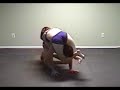 Frenchie gets Mav down and crunches his cranium in a head scissors.