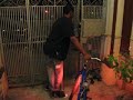 Geoffrey carries his bike to the street