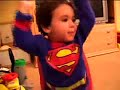 Superman at 2 years old, wearing slippers