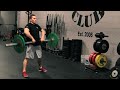 Matt Chan demonstrates the Sumo Deadlift High Pull at Rogue HQ using the Rogue bar and color competition bumpers.