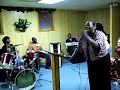 sunday night service in birmingham, alabama.  first lady quanita croom wood leading praise and worship. bishop wood on keyboard, son, sir charles on drums. daughter empress in background.  04/27/08