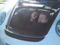Vicki Butler Henderson showing the boot space of a Porsche