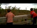 Two boys play on wood bridge
