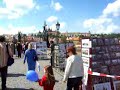 now it's sunny, and madhavi and jeremy cross the charles bridge in prague