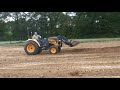 LX450 Cub-Cadet Yanmar Tractor Pushing Dirt with Loader