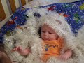 Baby Dallas playing in the garland... Baby Dallas playing in the garland...