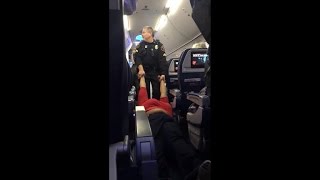 Woman Dragged Off Airplane by Police
