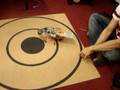 videos de Stamp Bug Robot automatically adjusting itself on the dart board.