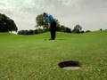 Tiger Woods putts a rubik's cube