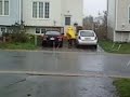 Postal worker delivering mail during hurricane Igor