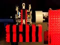 Lego Clock Escapement W14 (part of series W1 thru W14).Pushing a (long) pendulum at its lower end. The weight (500g) drops 25 cm in 1 hour, i.e. still too much for a 24h clock. This is necessary, however, too keep the gear train going; the pendulum can do with much less. The clutch that connects the gear train to the scape wheel helps to avoid frame distortions, resulting from the weight, to affect the bearing of the scape wheel.