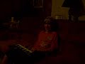 young boy lerans to plays music