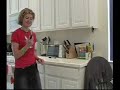 A girl tries to open a jar of applesauce.
