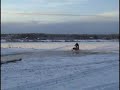 Old snowmobiles on water