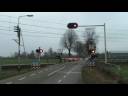 Dutch railroad crossing at Sevenum,the Netherlands,December 3,2008 and intercity train passing.