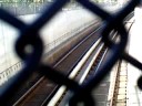 BART Train Through Chain-Link Fence