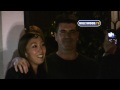 a somewhat portly looking simon cowell departs cecconi's after presumably having some supper with a lady friend, but not until graciously pausing for a quick pic with a fan.