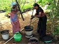 Two Women pounding charcoal into powder Two Women pounding charcoal into powder