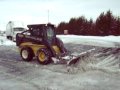 NEW HOLLAND SKID STEER LOADER PLOWING SNOW