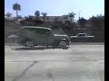A very old car traveling at high speeds to San Diego