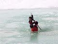 rescue team chief with sledge and co-driver, drive in to ice cold water and sink in the middle of the small lake, alpine resort Davos Parsenn