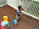 Ander sweeps the porch (11 months old)