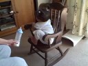Sailee climbs the rocking chair