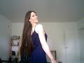Brunette brushing long hair in dress