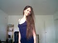 Brunette brushing long hair in dress