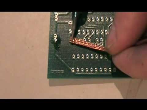 desoldering - Desoldering a Through Hole component by using a desoldering braid.