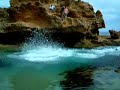 13 people jumping off rock pool