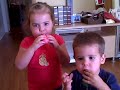 Sydney and Jackson try to blow up their balloons.