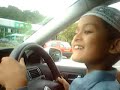 8 year old kid driving in car park