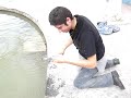 robot siendo bendecido por el agua del niño fidencio