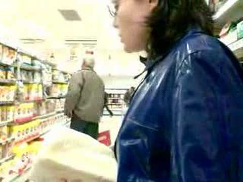 Rainweargirl - A video of Rainweargirl taken discreetly with a camera phone. She looks lovely in her blue PVC raincoat.
