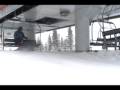 seated skibob rider unloading from chair lift