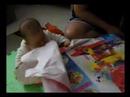 Baby Natalie unwrapping her Christmas gift