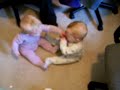Twins fight over a pacifier
