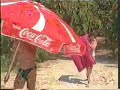 obstinate coca-cola umbrella in the wind in summer holiday
