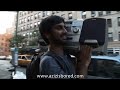 aziz ansari is forced to carry around a boombox playing the world's shittiest mixtape.