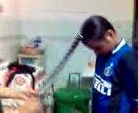 Sikh lady combing her son's hair
