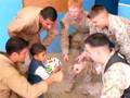 Marines pass out donated soccer balls to Iraqi kids
