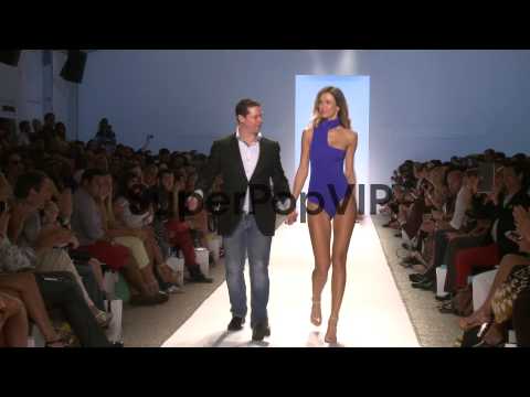 Designer Javier Madrigal and model walk the runway during...